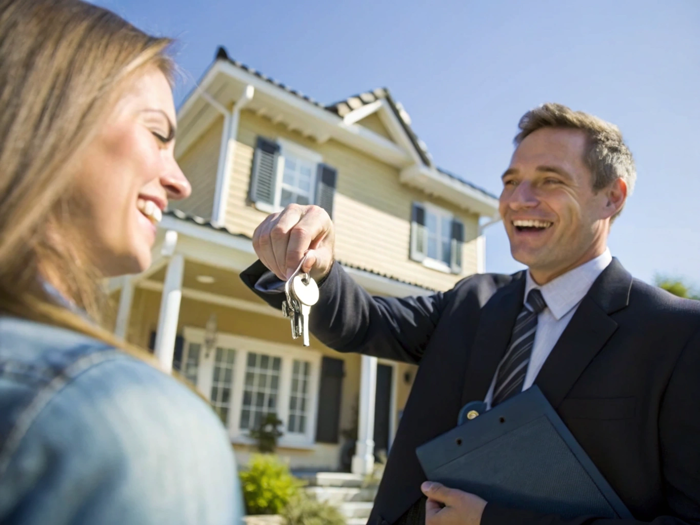 Homeowner receiving keys at front entrance of Ontario residential home